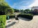Outdoor patio area with a grill, seating, and manicured hedges for privacy at 220 Renaissance Ne Pkwy # 1115, Atlanta, GA 30308