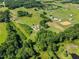 An aerial perspective of land with mature trees, water features, horse enclosures, and open spaces at 226 Euharlee Five Forks Rd, Kingston, GA 30145