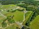 Expansive aerial view of a property featuring large fields, mature trees, and a home nestled in a serene, pastoral setting at 226 Euharlee Five Forks Rd, Kingston, GA 30145