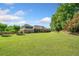 Lush backyard with manicured lawn and mature trees complementing the classic brick exterior of the residence at 226 Euharlee Five Forks Rd, Kingston, GA 30145