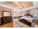 Pink bedroom with hardwood floors, a ceiling fan, and access to a sitting area with a fireplace at 226 Euharlee Five Forks Rd, Kingston, GA 30145