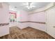 A cozy bedroom featuring plush brown carpet, decorative wallpaper, and a ceiling fan for added comfort at 226 Euharlee Five Forks Rd, Kingston, GA 30145