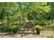 Charming bridge surrounded by lush greenery and potted yellow flowers, creating a peaceful and inviting outdoor space at 226 Euharlee Five Forks Rd, Kingston, GA 30145