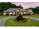Brick home with mature landscaping features a circular driveway and charming curb appeal at 226 Euharlee Five Forks Rd, Kingston, GA 30145
