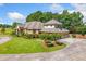 Charming brick home featuring an attached three-car garage, manicured landscaping, and a circular driveway at 226 Euharlee Five Forks Rd, Kingston, GA 30145