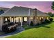 Rear exterior of home with an elongated covered porch supported by columns and lush landscaping at 226 Euharlee Five Forks Rd, Kingston, GA 30145