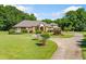 Stately brick home features a circular driveway and lush, well-maintained landscaping at 226 Euharlee Five Forks Rd, Kingston, GA 30145