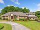 Impressive brick home featuring a grand entrance, lush landscaping, and a circular driveway, exuding timeless elegance at 226 Euharlee Five Forks Rd, Kingston, GA 30145