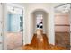 Hallway with wood floors, arched doorways, and views into adjacent rooms with carpeted floors at 226 Euharlee Five Forks Rd, Kingston, GA 30145