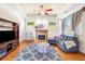 Bright living room with hardwood floors, a fireplace, large windows, and comfortable seating creating a relaxing space at 226 Euharlee Five Forks Rd, Kingston, GA 30145