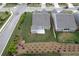 Aerial view highlighting a well-manicured backyard, concrete patio, tasteful landscaping, and charming neighborhood at 242 Aspen Way, Dallas, GA 30157
