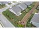 An aerial view showcasing a charming home with a well-maintained lawn, attractive landscaping, and neat rows of manicured shrubbery at 242 Aspen Way, Dallas, GA 30157