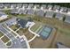 An aerial view highlighting community tennis and bocce ball courts, attractive landscaping, and clubhouse with seating at 242 Aspen Way, Dallas, GA 30157