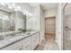 Bathroom with double vanity, granite countertops, tiled floors, and tiled shower at 242 Aspen Way, Dallas, GA 30157