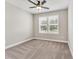 Neutral bedroom featuring carpet flooring, a ceiling fan, and ample natural light from a large window at 242 Aspen Way, Dallas, GA 30157