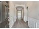 Elegant foyer with hardwood flooring, wainscoting, arched doorway and natural light leading into a living space at 242 Aspen Way, Dallas, GA 30157