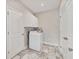 Bright laundry room with overhead cabinets and tiled floors at 242 Aspen Way, Dallas, GA 30157