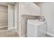 Well-lit laundry room features white cabinetry and a washer/dryer at 242 Aspen Way, Dallas, GA 30157