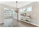 Open-concept living area featuring a modern light fixture and lots of windows at 242 Aspen Way, Dallas, GA 30157