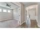 Light-filled office space with glass doors opening to a hallway with wood floors, an arched ceiling and the front door at 242 Aspen Way, Dallas, GA 30157