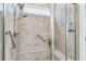 Updated tile shower featuring a built-in seat and modern fixtures at 242 Aspen Way, Dallas, GA 30157