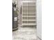 Installed shelving unit next to water heater for storage options at 242 Aspen Way, Dallas, GA 30157