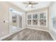 Bright sunroom with hardwood floors, windows, and access to the backyard at 242 Aspen Way, Dallas, GA 30157