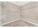 Spacious walk-in closet with metal shelving and neutral carpeting at 242 Aspen Way, Dallas, GA 30157