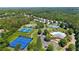 Aerial view showcases community amenities, including tennis courts, swimming pool, and lush landscaping at 314 Santa Anita Ave, Woodstock, GA 30189