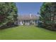 Expansive backyard with lush green lawn, mature trees, and potential for outdoor activities and relaxation at 314 Santa Anita Ave, Woodstock, GA 30189