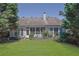 Beautiful backyard features a well-maintained lawn, established trees, and a charming, partially lattice-fenced patio area at 314 Santa Anita Ave, Woodstock, GA 30189