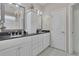 Elegant bathroom featuring a dual sink vanity with granite counters and classic lighting at 314 Santa Anita Ave, Woodstock, GA 30189