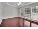 Bedroom features hardwood floors, ceiling fan, and natural light from large windows at 314 Santa Anita Ave, Woodstock, GA 30189