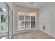 Bright breakfast nook with large windows, a decorative light fixture, and door to screened porch at 314 Santa Anita Ave, Woodstock, GA 30189