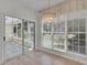 Bright breakfast nook with large windows, a decorative light fixture, and door to screened porch at 314 Santa Anita Ave, Woodstock, GA 30189