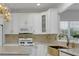 Bright kitchen features white cabinetry, gold hardware, marble countertops, and stainless appliances at 314 Santa Anita Ave, Woodstock, GA 30189