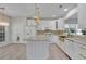Bright kitchen features white cabinetry, gold hardware, marble countertops, and decorative light fixtures at 314 Santa Anita Ave, Woodstock, GA 30189