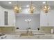 Bright kitchen features white cabinetry, gold hardware, marble countertops, and decorative light fixtures at 314 Santa Anita Ave, Woodstock, GA 30189