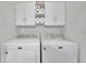 Bright laundry room features newer model Maytag washer and dryer appliances at 314 Santa Anita Ave, Woodstock, GA 30189