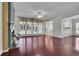 Open-concept living room with hardwood floors, a fireplace, and views into the kitchen and dining areas at 314 Santa Anita Ave, Woodstock, GA 30189