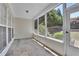 Cozy screened porch with stone flooring and views of the wooded backyard at 314 Santa Anita Ave, Woodstock, GA 30189