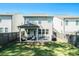 Large fenced backyard with a covered patio featuring comfortable seating and a grill, perfect for outdoor entertaining at 4406 Richmond Court Ct, Stone Mountain, GA 30083