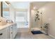 Bright bathroom featuring a separate shower and bathtub, offering a luxurious and spa-like experience at 4406 Richmond Court Ct, Stone Mountain, GA 30083