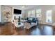 Cozy living room with fireplace, lots of natural light, and comfortable seating, perfect for relaxation and entertaining at 4406 Richmond Court Ct, Stone Mountain, GA 30083