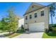 Charming two-story home with a two-car garage and manicured front lawn on a clear day at 4406 Richmond Ct, Stone Mountain, GA 30083