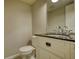 Bathroom featuring a vanity sink, toilet, and mirror at 924 Park Gate Pl, Stone Mountain, GA 30083