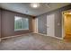 Bedroom with neutral walls, carpet, a window, and two doors at 924 Park Gate Pl, Stone Mountain, GA 30083