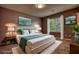 Comfortable bedroom with king bed, bedside tables, and a picturesque window view at 924 Park Gate Pl, Stone Mountain, GA 30083