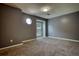 Bedroom features a gray accent wall, neutral carpet and an octagonal window for plenty of natural light at 924 Park Gate Pl, Stone Mountain, GA 30083