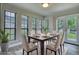 Bright dining room features a dining table with six chairs near four large windows with a backyard view at 924 Park Gate Pl, Stone Mountain, GA 30083